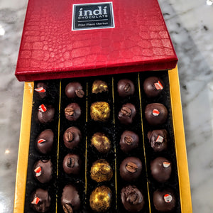 indi chocolate Truffles are made from the beans we source around the world and make into chocolate in our Pike Place Market factory on Western Ave. Flavors change seasonally. Vegan  because our beans taste so good. Made without soy or gluten.